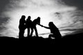 Silhouette of helping hand between two climber Royalty Free Stock Photo